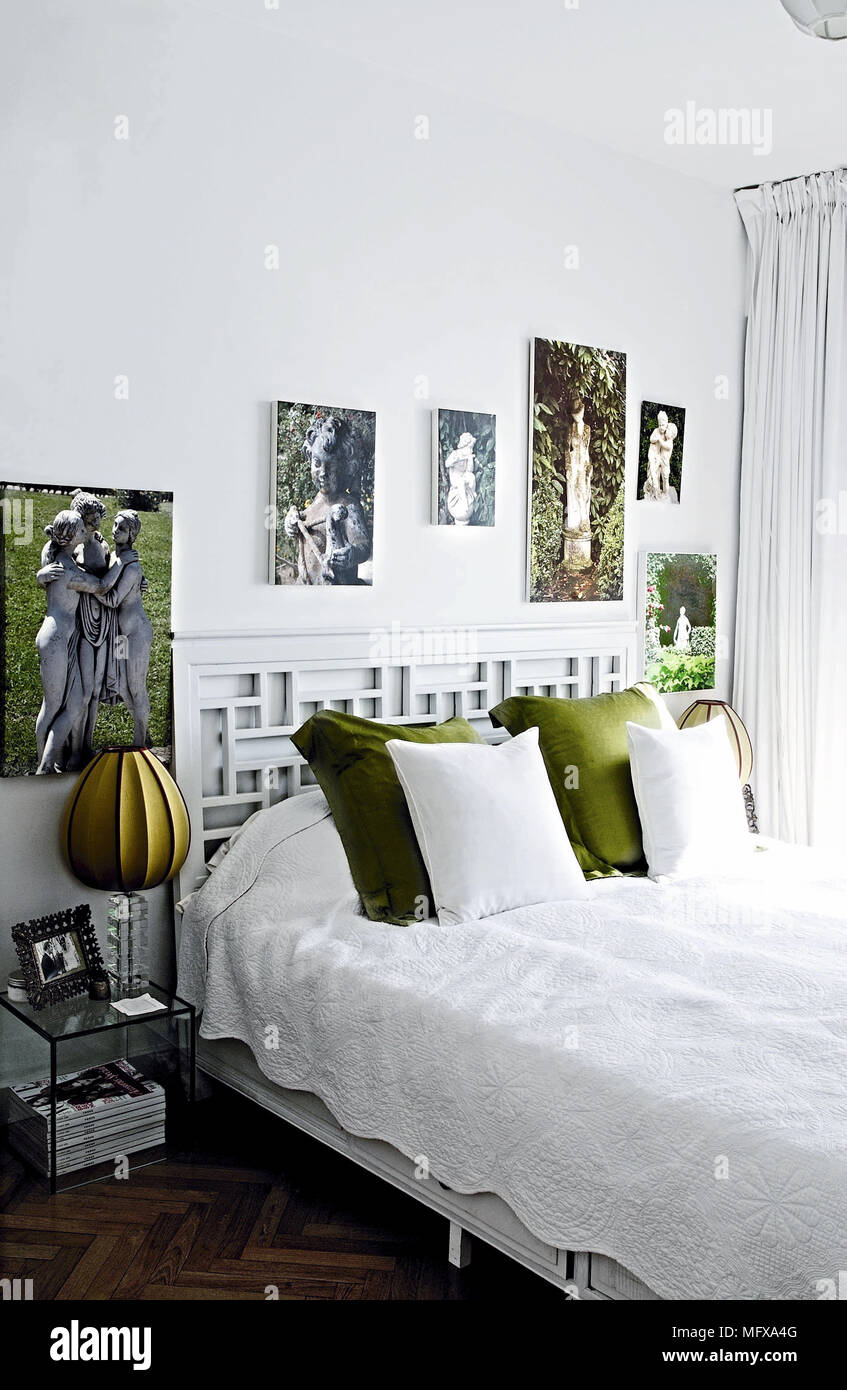 Lamp on bedside table next to double bed in modern bedroom Stock Photo