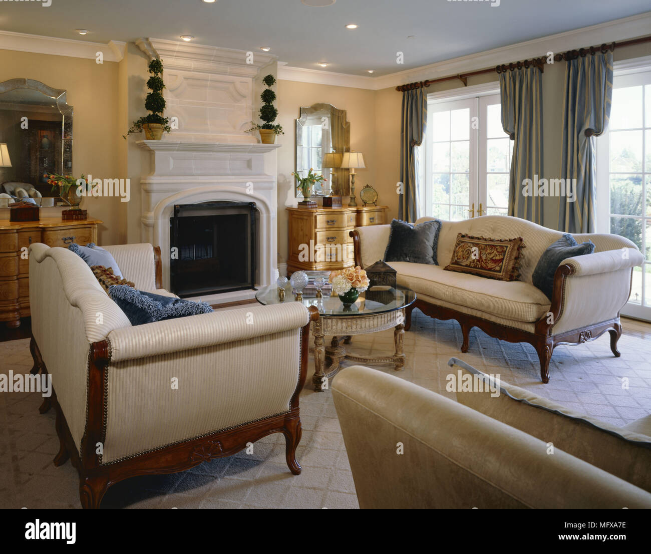 Pair of period style sofas facing each other across table in front of