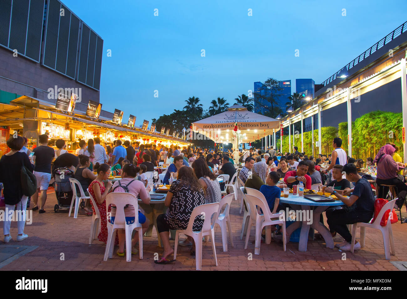 SINGAPORE - JAN 14, 2017 : People at popular food court in Singapore. Inexpensive food courts are numerous in the city so most Singaporeans dine out a Stock Photo