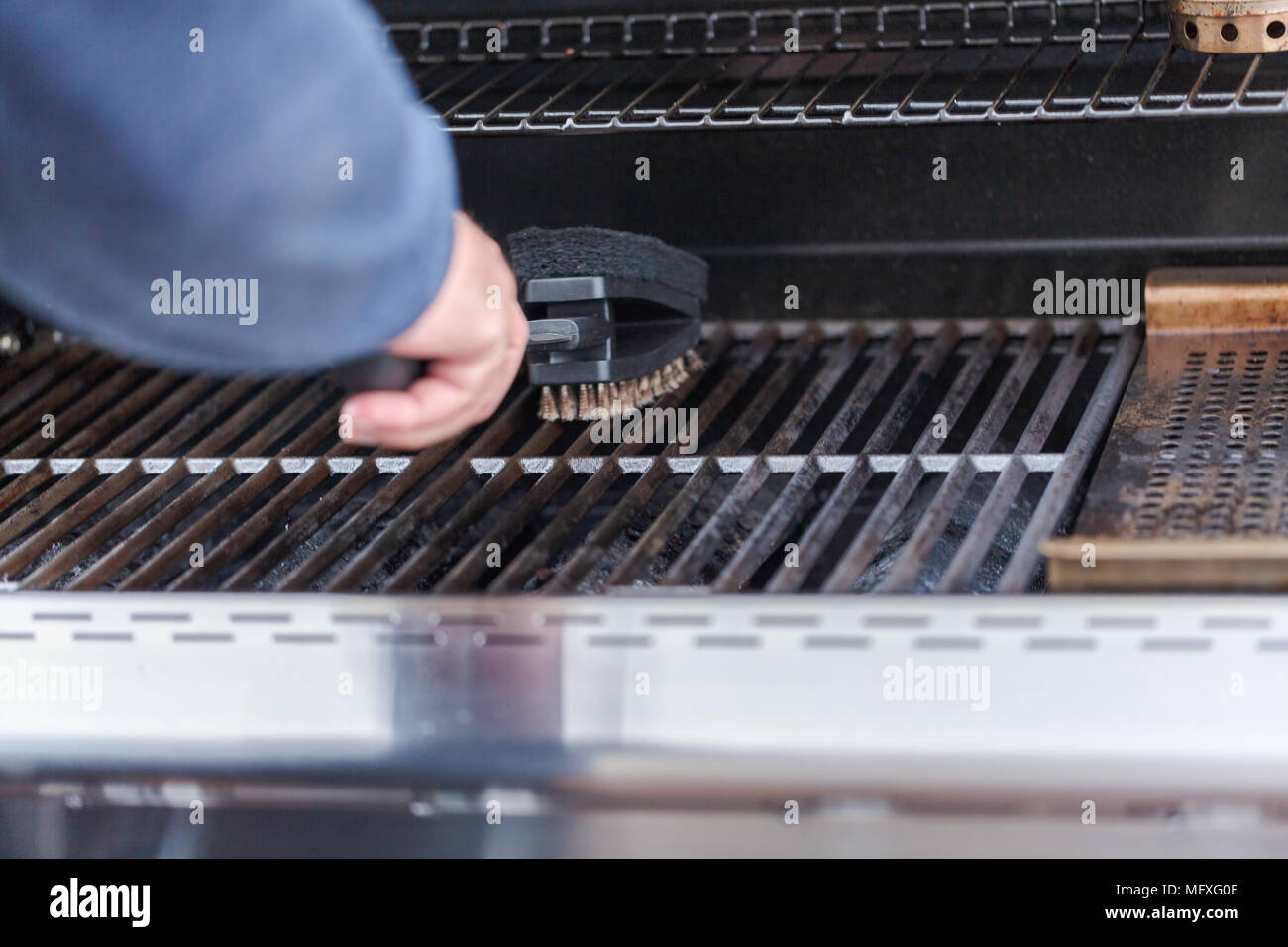 Cleaning outdoor gas grill before next grilling Stock Photo Alamy