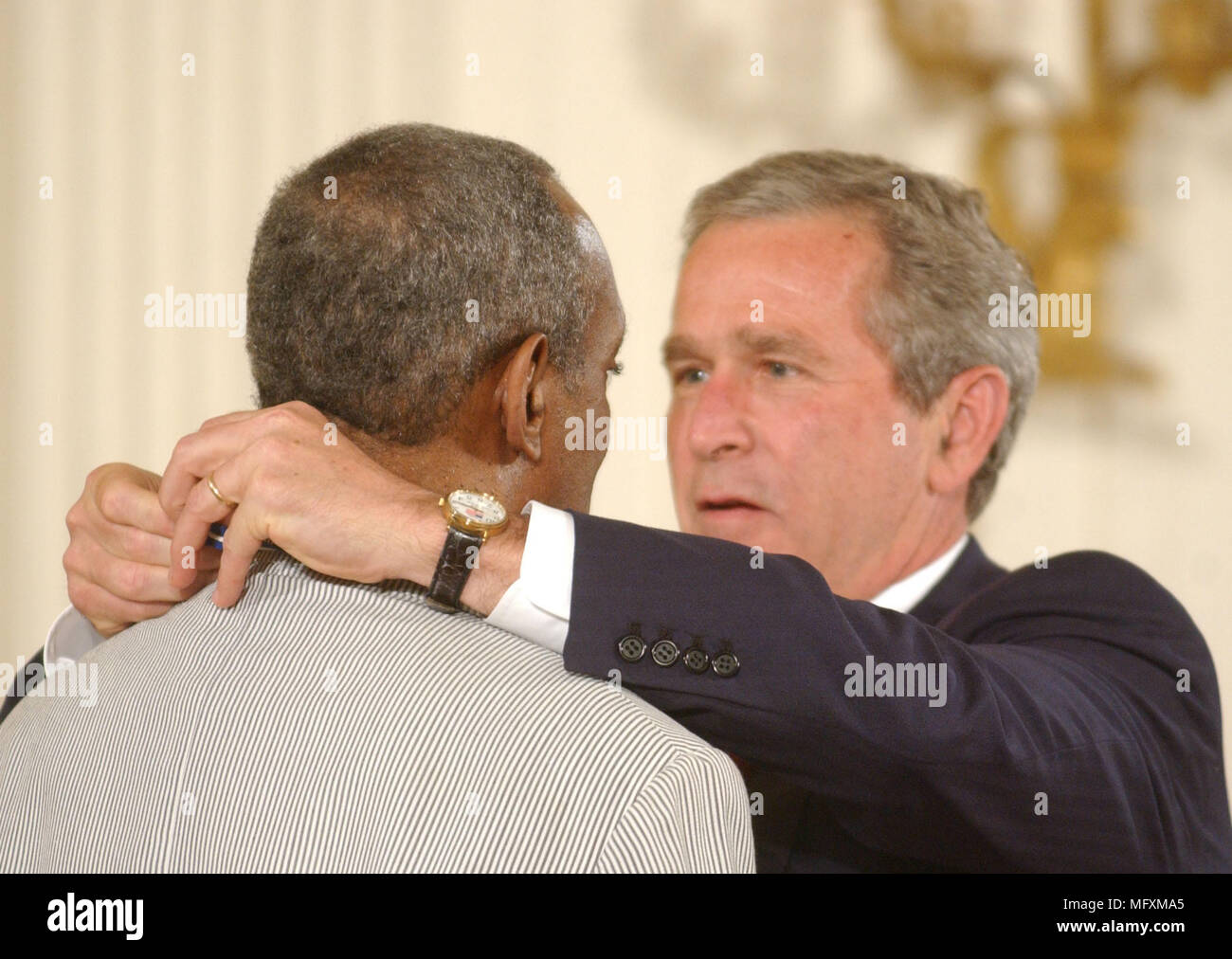 Washington, District of Columbia, USA. 9th July, 2002. Washington, DC - July 9, 2002 -- United States President George W. Bush honors Bill Cosby with the Presidential Medal of Freedom during a ceremony in the East Room of the White House in Washington, DC on July 9, 2002.Credit: Ron Sachs/CNP Credit: Ron Sachs/CNP/ZUMA Wire/Alamy Live News Stock Photo