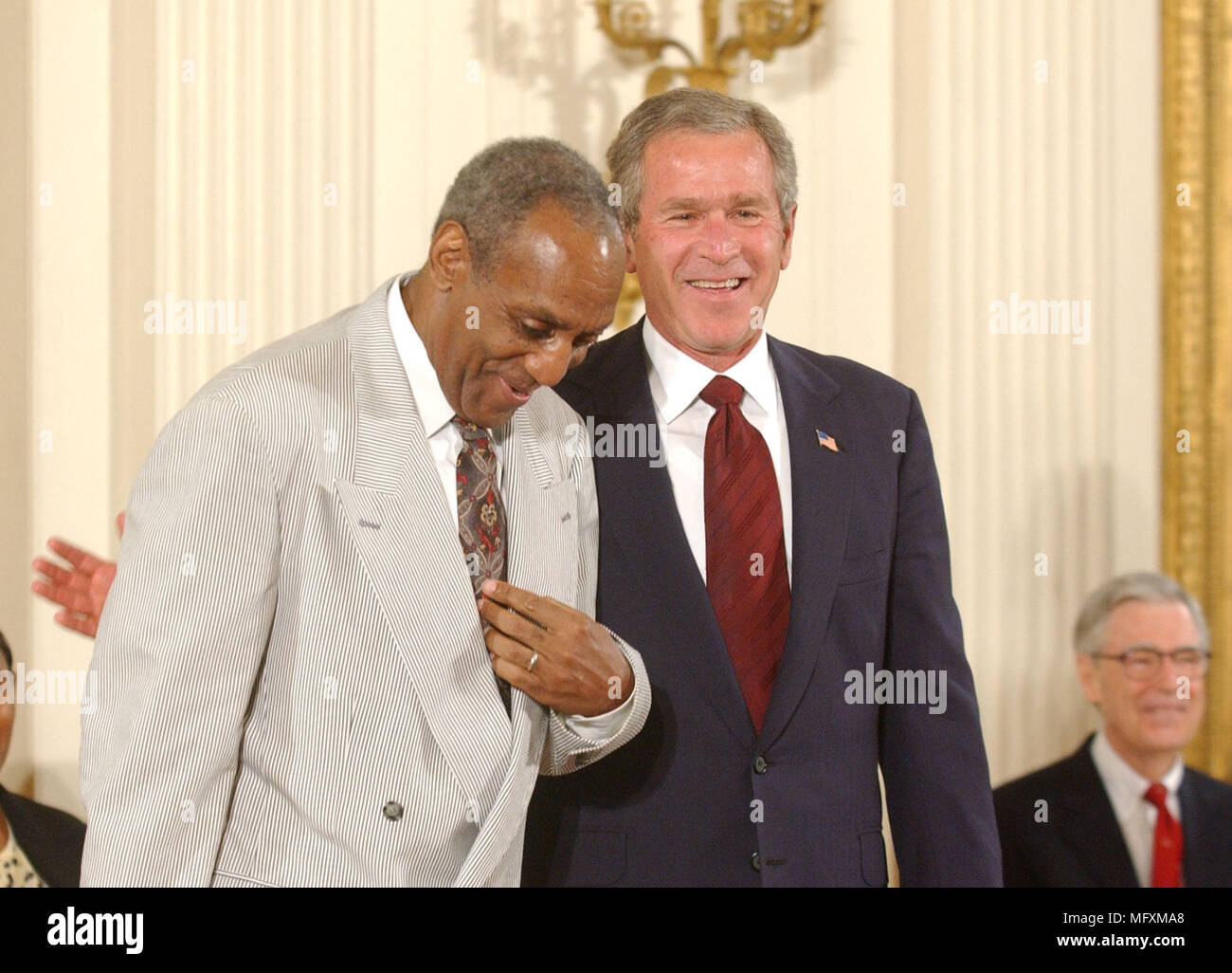 Washington, District of Columbia, USA. 9th July, 2002. Washington, DC - July 9, 2002 -- United States President George W. Bush honors Bill Cosby with the Presidential Medal of Freedom during a ceremony in the East Room of the White House in Washington, DC on July 9, 2002.Credit: Ron Sachs/CNP Credit: Ron Sachs/CNP/ZUMA Wire/Alamy Live News Stock Photo