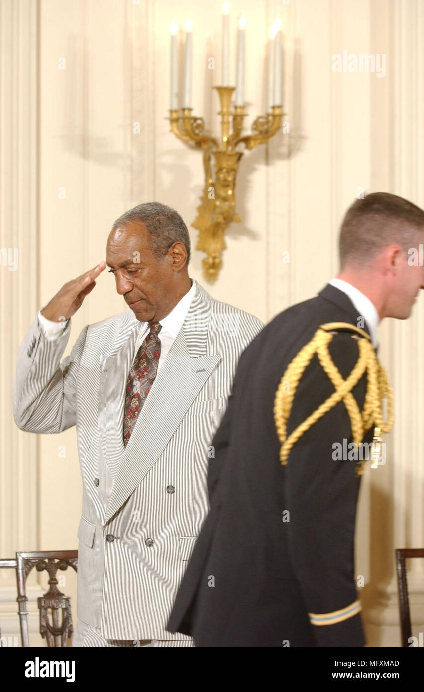 Washington, District of Columbia, USA. 9th July, 2002. Bill Cosby salutes his escort as he takes his seat prior to the ceremony where U.S. President George W. Bush honored the recipients of the Presidential Madal of Freedom during a ceremony in the East Room of the White House in Washington, DC on July 9, 2002.Credit: Ron Sachs/CNP Credit: Ron Sachs/CNP/ZUMA Wire/Alamy Live News Stock Photo