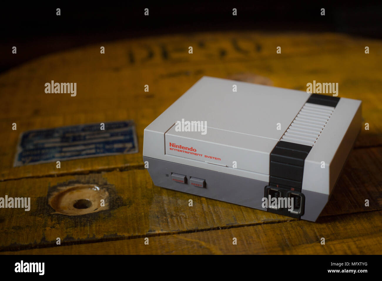 A Nintendo Classic Mini 'Nintendo Entertainment System' video game console. The Kyoto based video game company Nintendo ended it’s comeback year revenue with worth $9 Billion after a glorious year 2017 notably with the launch of the hybrid console the Nintendo Switch, mini retro vintage game consoles such as the Nintendo Entertainment System and Super Nintendo as well as its mobile phone video games. Stock Photo