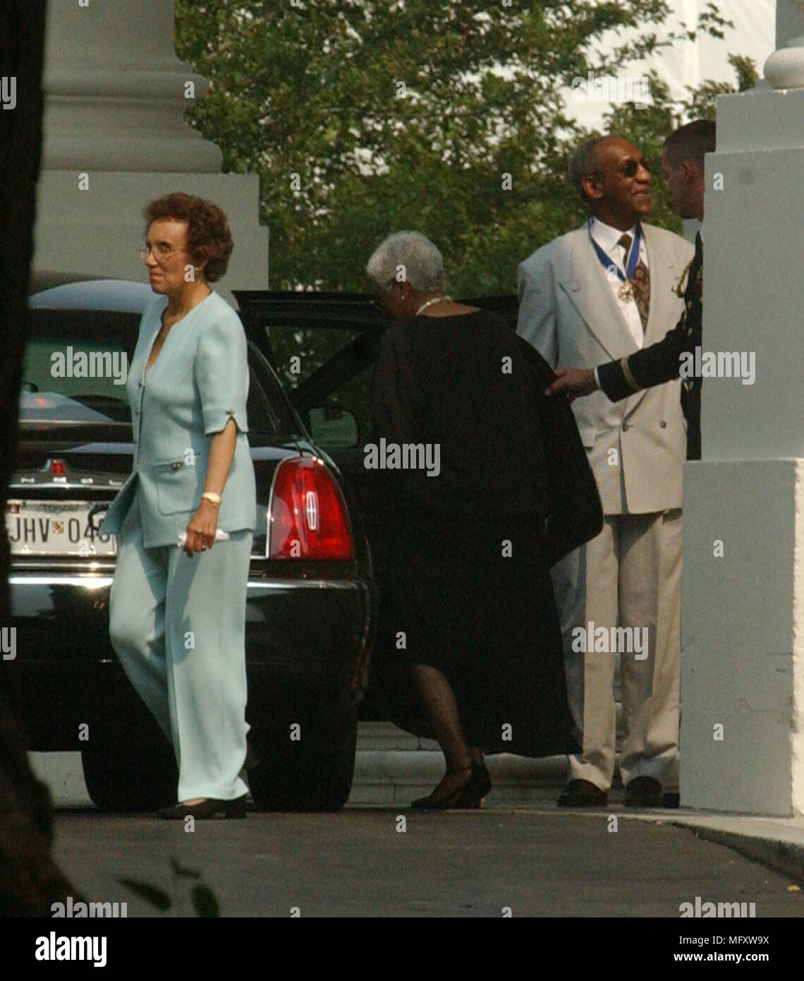 Bill Cosby departs the White House after receiving the Presidential Madal of Freedom from U.S. President George W. Bush during a ceremony in the East Room of the White House in Washington, DC on July 9, 2002.Credit: Ron Sachs/CNP /MediaPunch Stock Photo