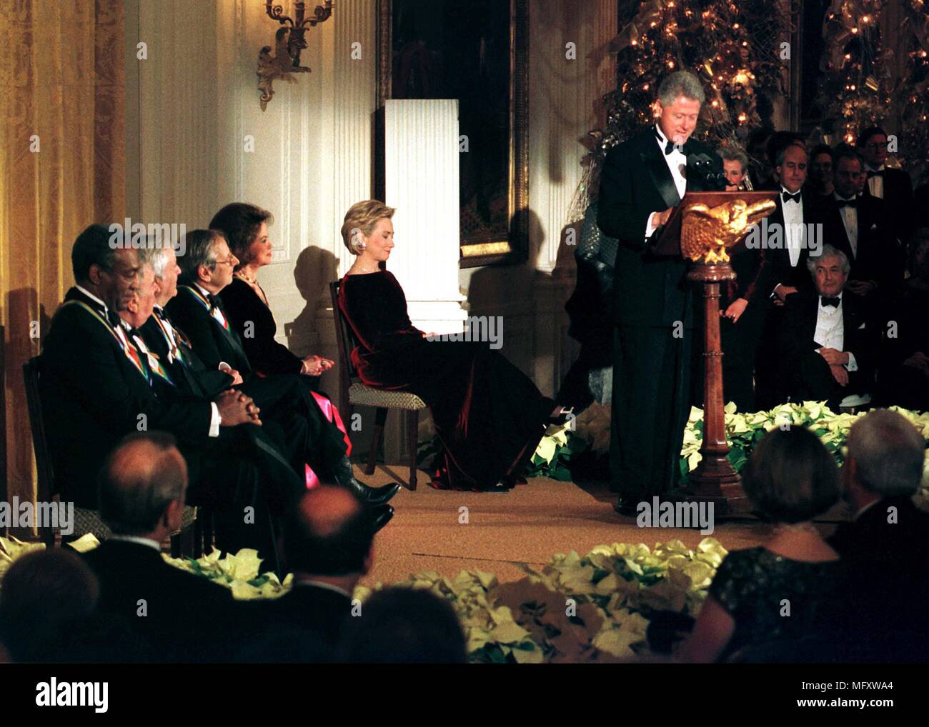 1998 Kennedy Center honorees listen to United States President Bill Clinton's remarks in their honor in the East Room of the White House in Washington, DC on December 6, 1998. Seated (L-R) Bill Cosby, John Kander, Fred Ebb, Andre Previn, and Shirley Temple Black. (Willie Nelson is not visible).Credit: Ron Sachs - CNP /MediaPunch Stock Photo