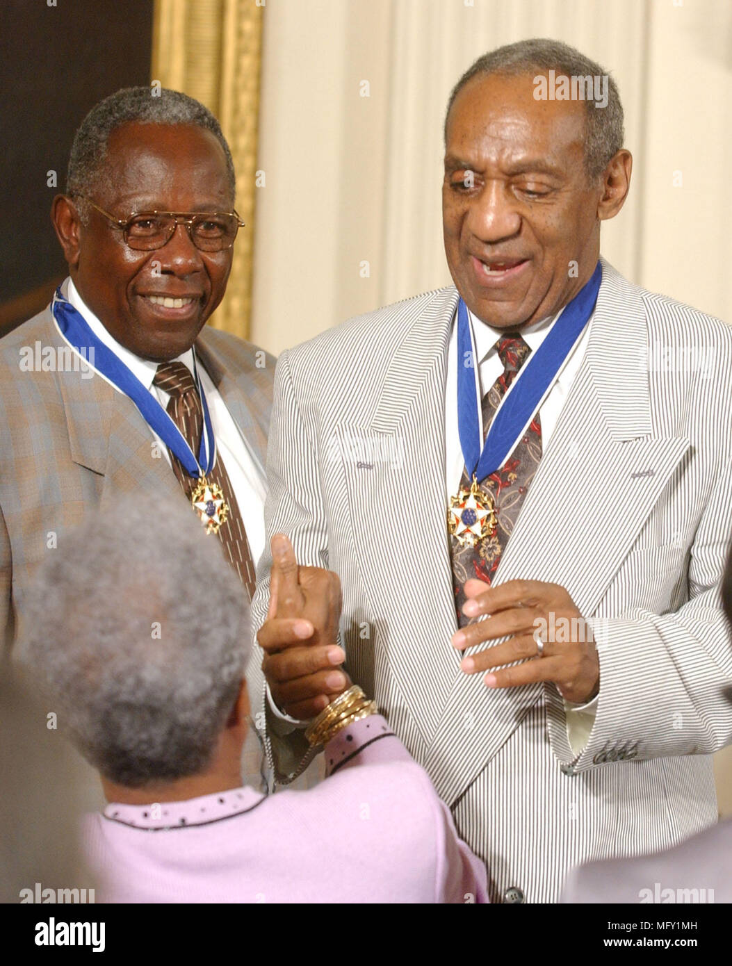 Washington, USA. 09th July, 2002. FILED - Hank Aaron and Bill Cosby accept congratulations after they received the Presidential Medal of Freedom from United States President George W. Bush during a ceremony in the East Room of the White House in Washington, DC on July 9, 2002.Credit: Ron Sachs/CNP - NO WIRE SERVICE · Credit: Ron Sachs/Consolidated News Photos/Ron Sachs/CNP/dpa/Alamy Live News Stock Photo
