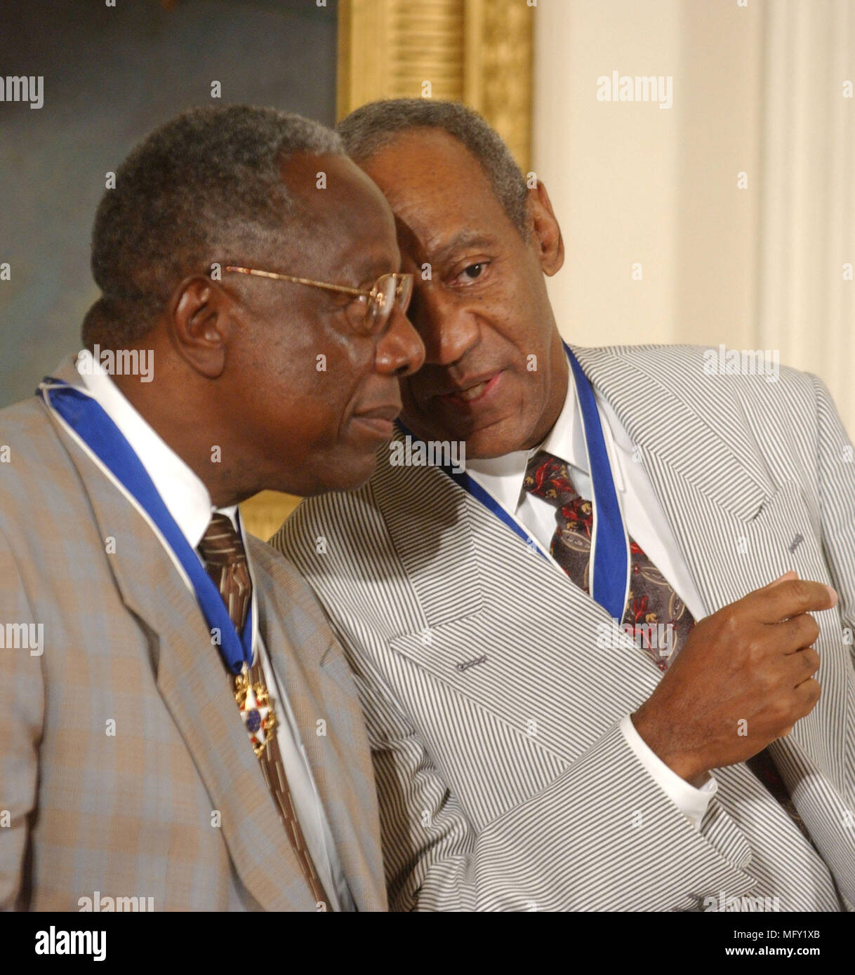 Washington, USA. 09th July, 2002. FILED - Hank Aaron and Bill Cosby share a thought after they received the Presidential Medal of Freedom from United States President George W. Bush during a ceremony in the East Room of the White House in Washington, DC on July 9, 2002.Credit: Ron Sachs/CNP - NO WIRE SERVICE · Credit: Ron Sachs/Consolidated News Photos/Ron Sachs/CNP/dpa/Alamy Live News Stock Photo