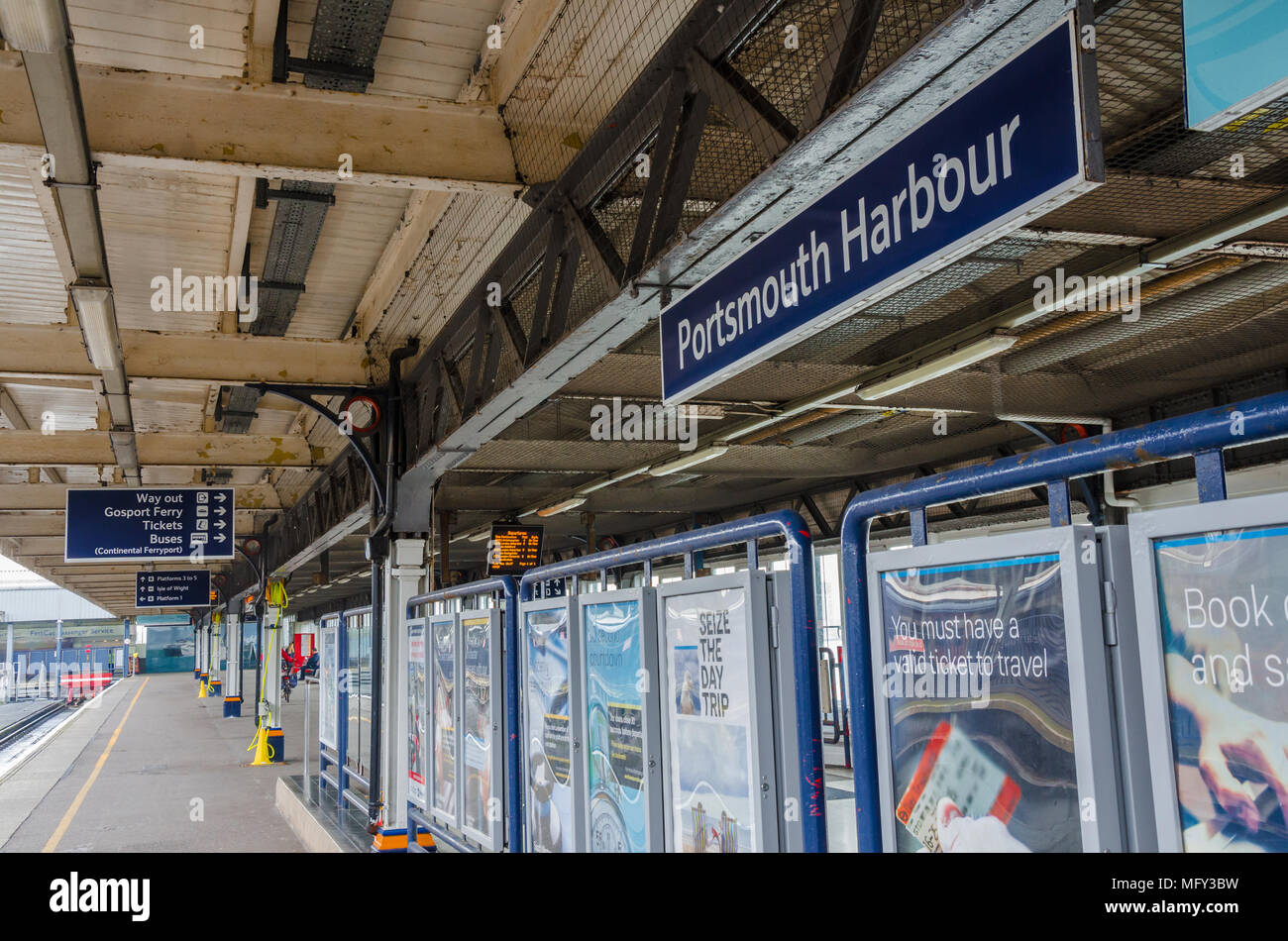 Signs and advertising boards on the platform at Portsmouth Harbour Railway Station. Stock Photo