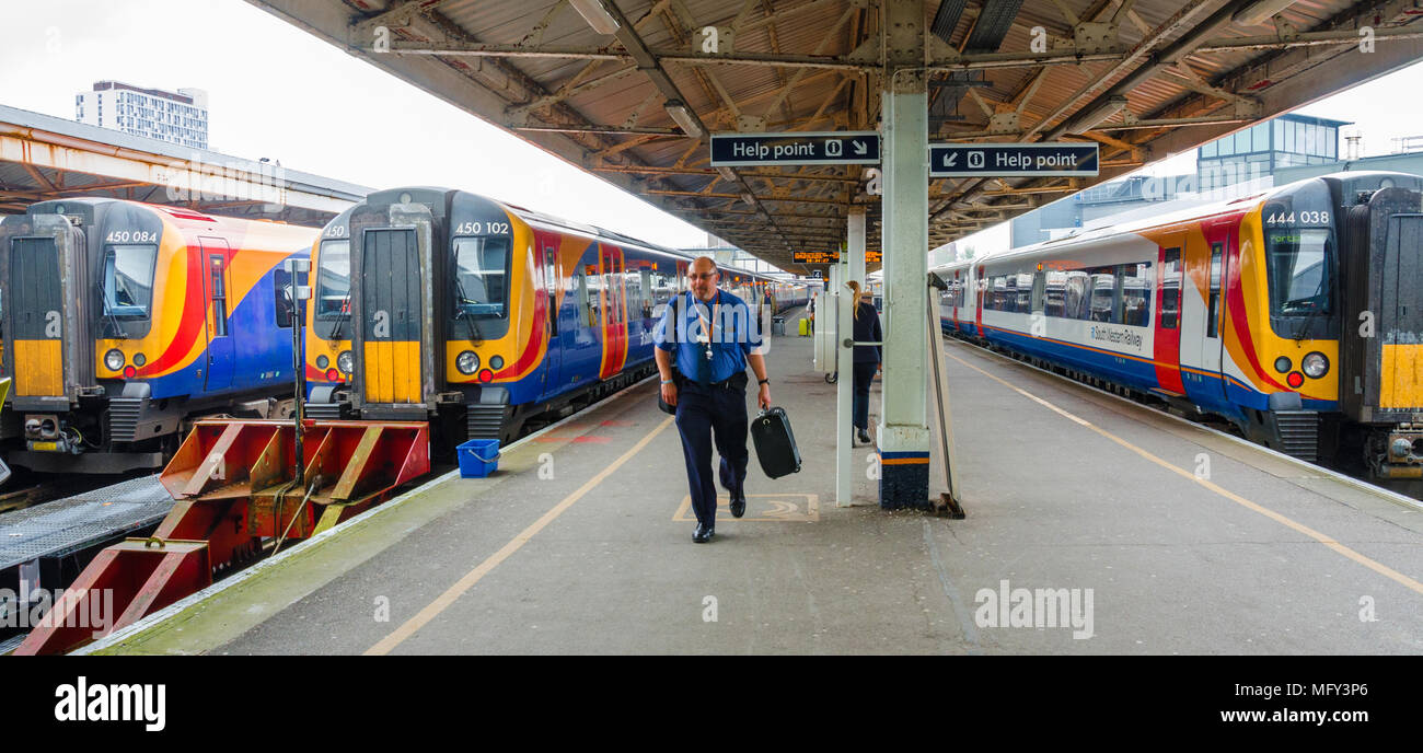 Trains sit in the platform at Portsmouth Harbour Railway Station. Stock Photo