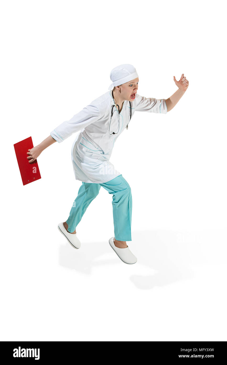 Beautiful young woman in white coat running at studio. Full length