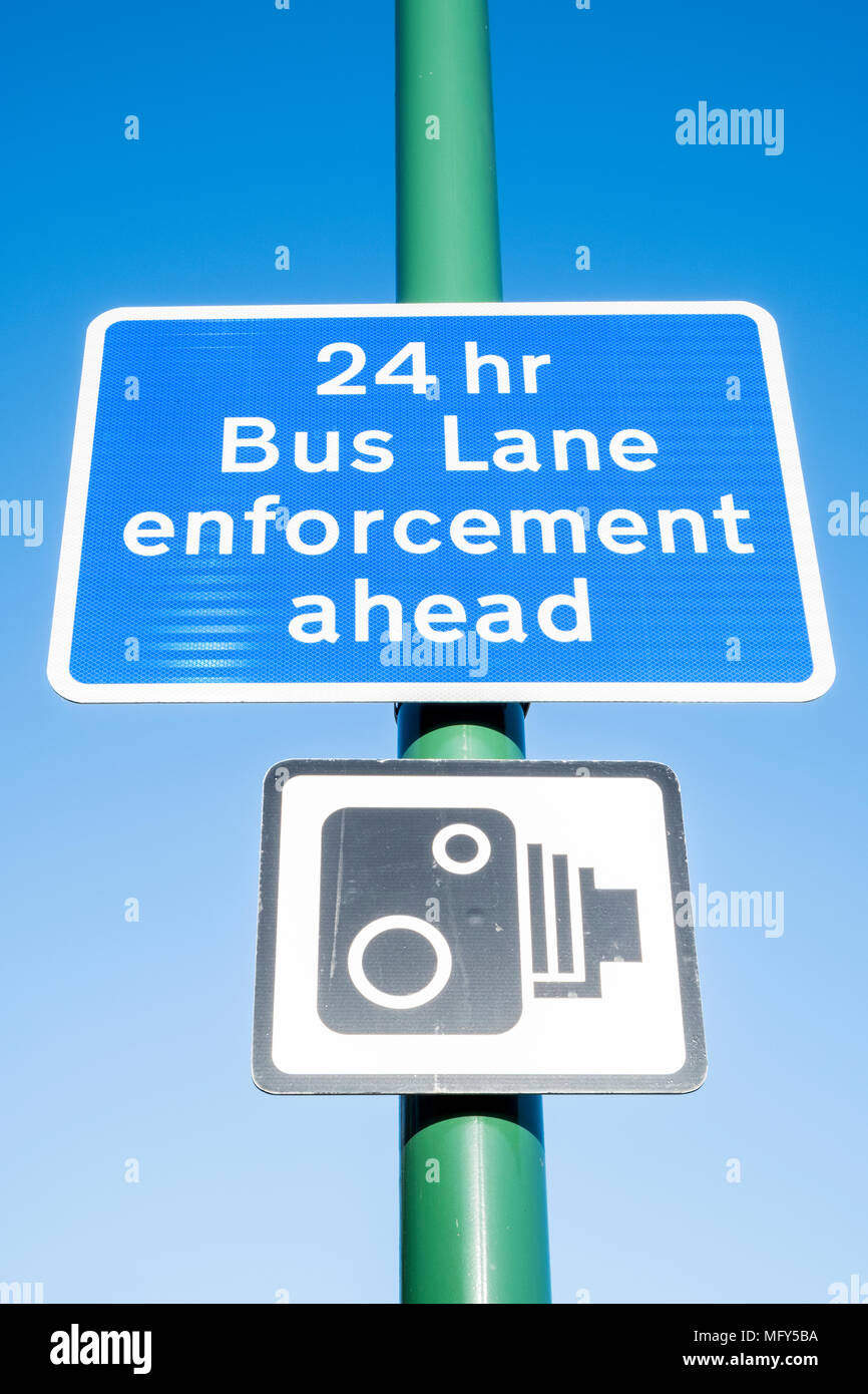 Road traffic signs. 24 hour bus lane enforcement ahead sign above a CCTV monitoring sign, Nottingham, England, UK Stock Photo