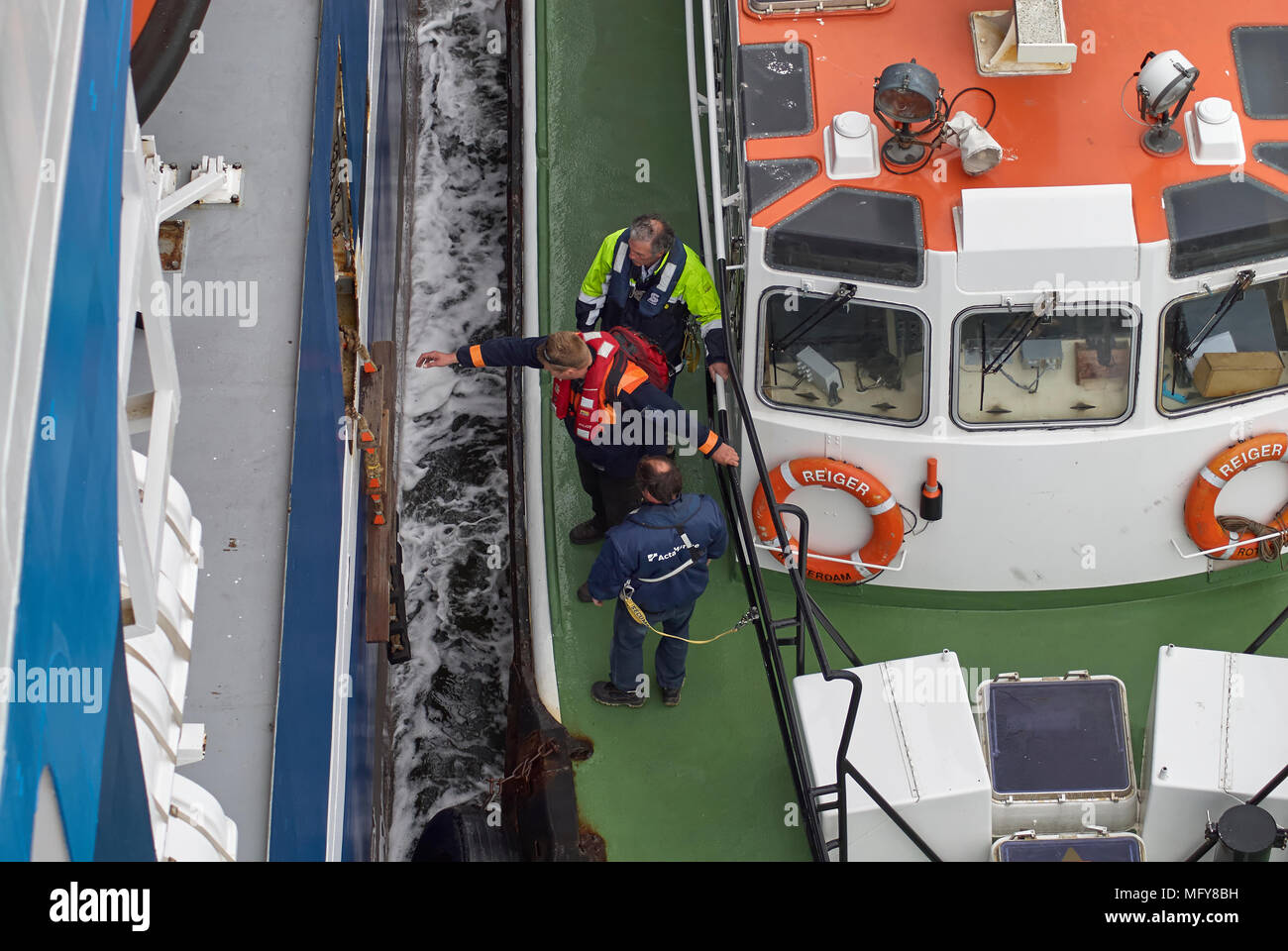 One of the Dutch Pilots from Den Helder Port stepping over on to the Pilot Ladder of the Seismic Vessel, so that he can bring the Vessel into port, Ne Stock Photo