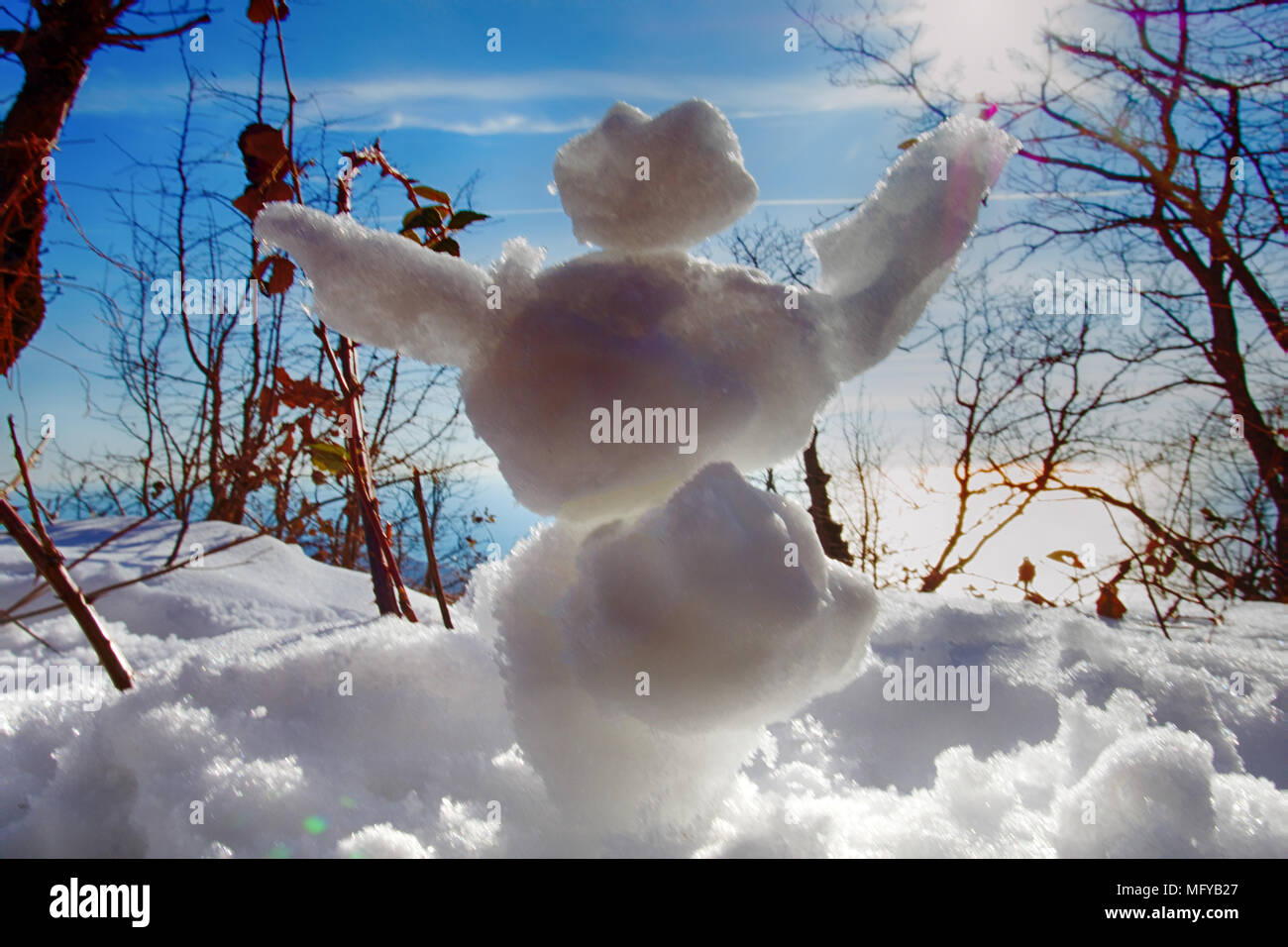 Funny Frosty (snowman) in forest in rays of sun, against light. Winter fun,  make snow. Small figures from snow for children and youth. Christmas enter  Stock Photo - Alamy