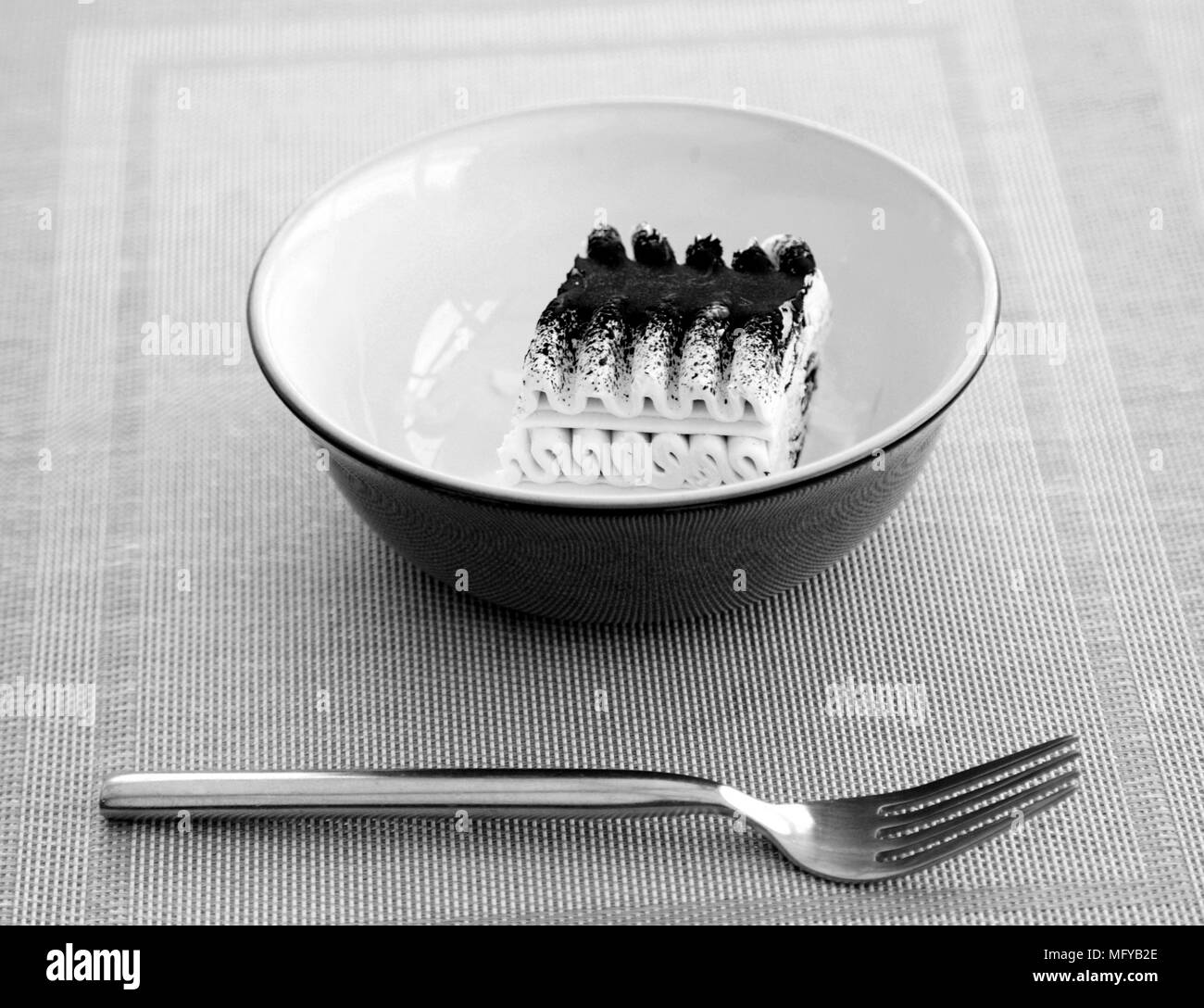 Viennetta ice cream in a blue dish with a fork Stock Photo