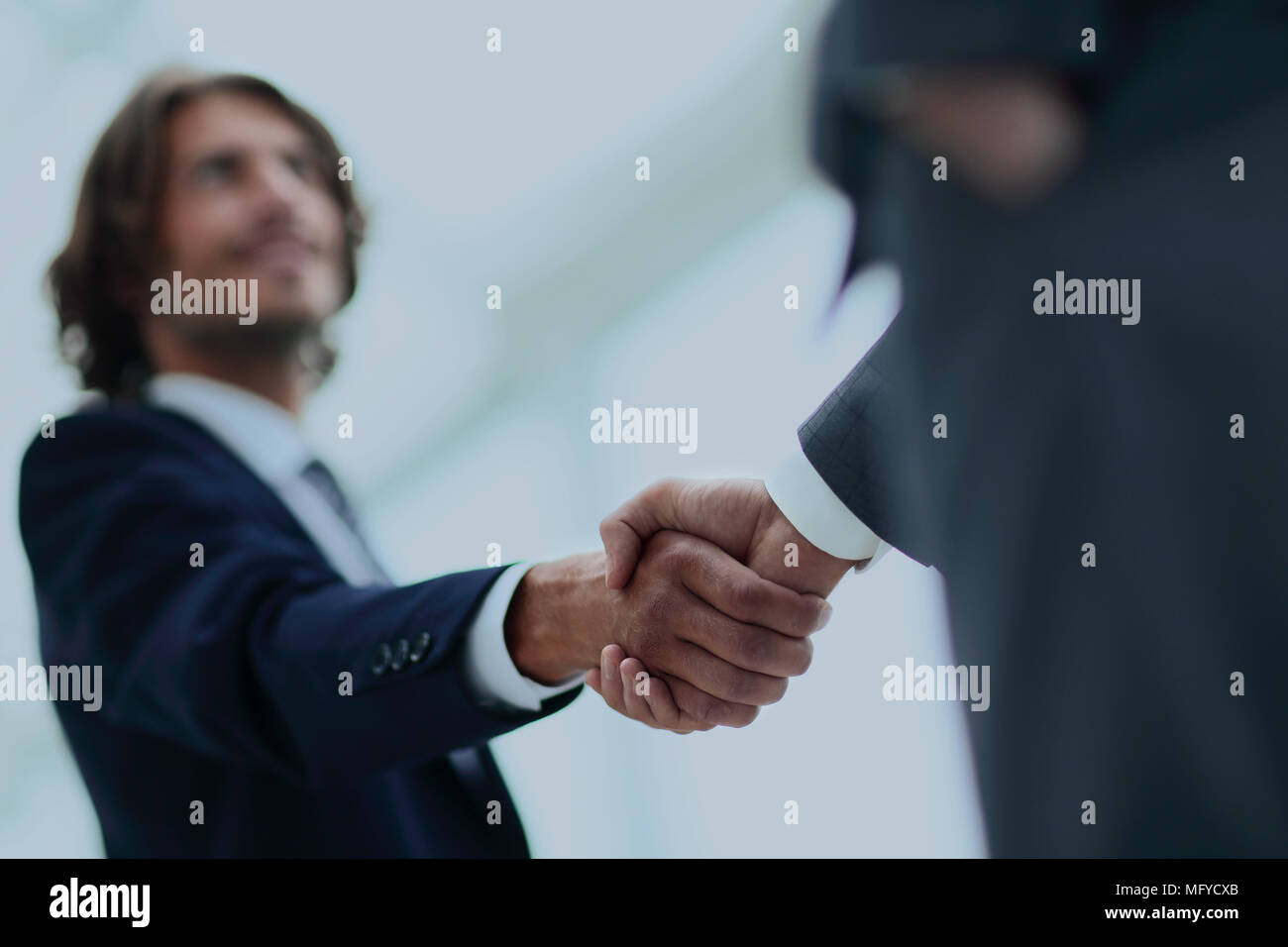Two businessman shaking hands greeting each other Stock Photo - Alamy