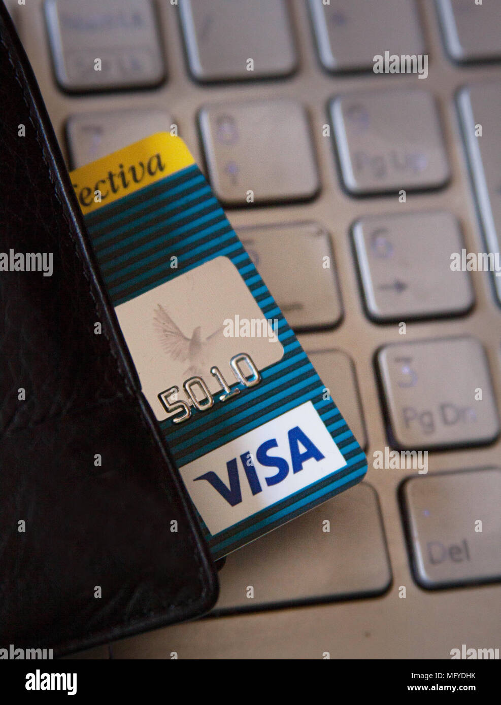 Macro of four credit card on a computer keyboard. Electronic online payment Stock Photo