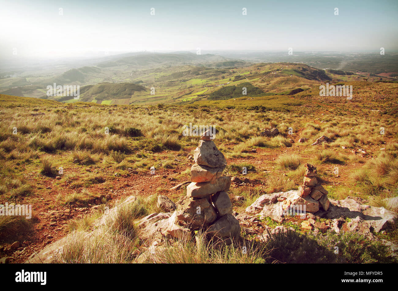 Mountain hiking trail with stone piles or cairns marking the way Stock Photo