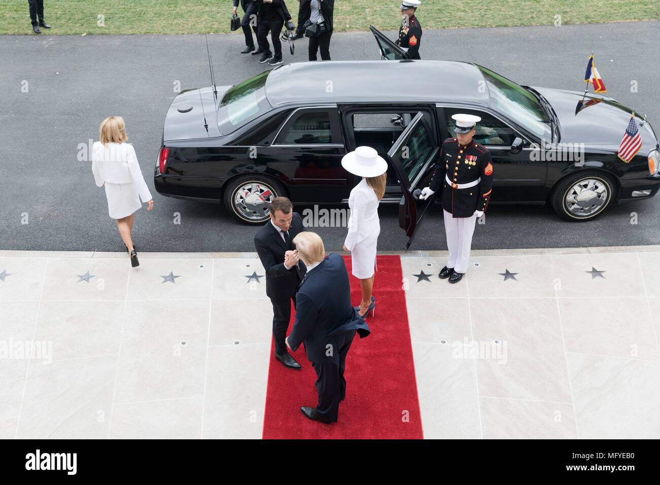 U.S. President Donald Trump and First Lady Melania Trump welcome French President Emmanuel Macron and his wife Brigitte Macron on arrival to the South Lawn for the State Visit at the White House April 24, 2018 in Washington, DC. Stock Photo