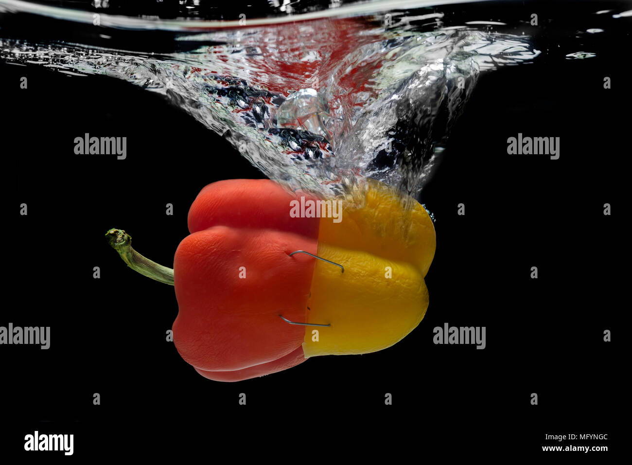 Abstract yellow-red pepper, splash of water. Stock Photo
