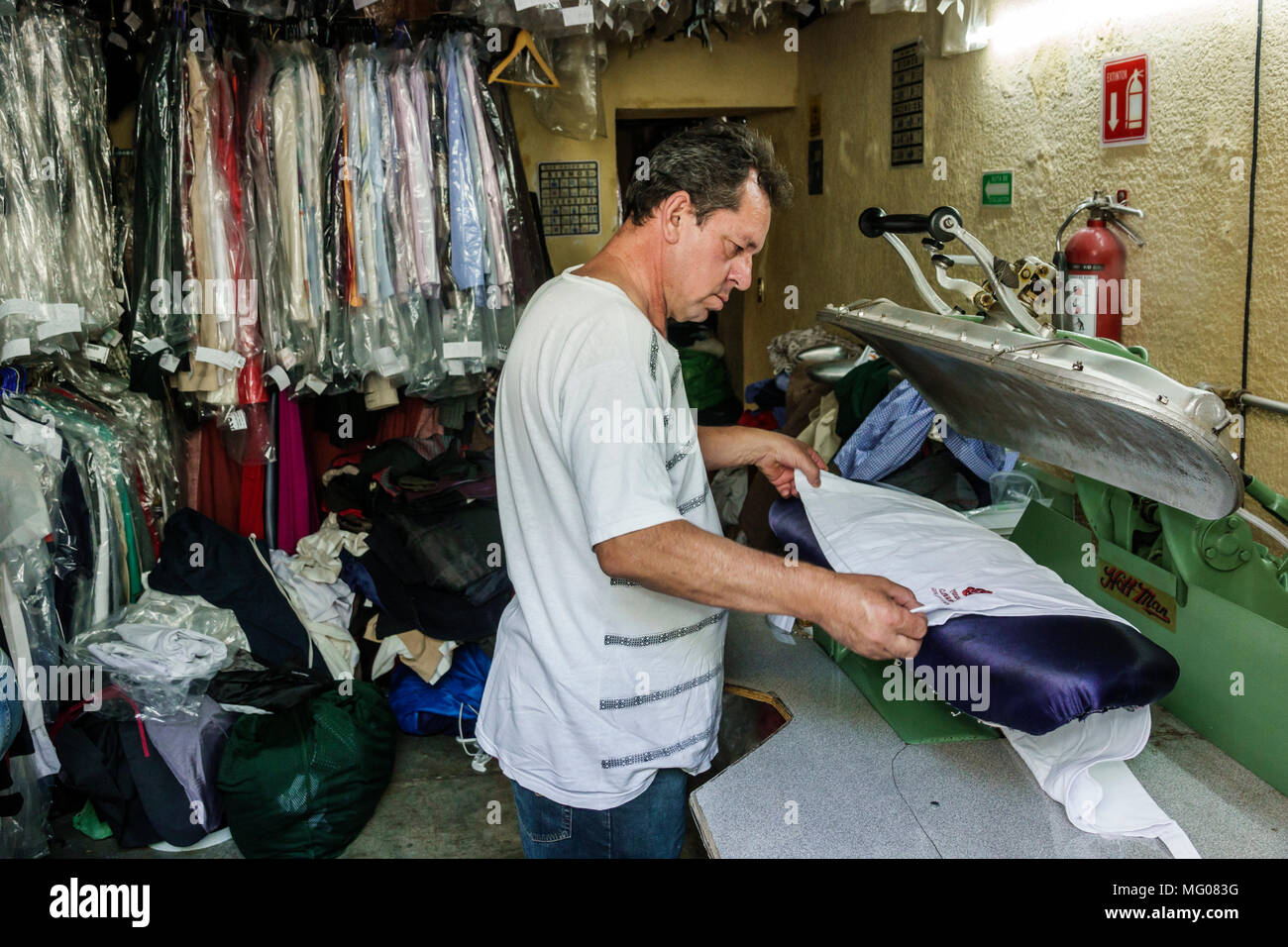 Mexico City,Cuauhtemoc,Mexican,Hispanic,historic Center Centre,Calle Regina,dry cleaner cleaning,man men male,working,pressing,ironing,manager,employe Stock Photo