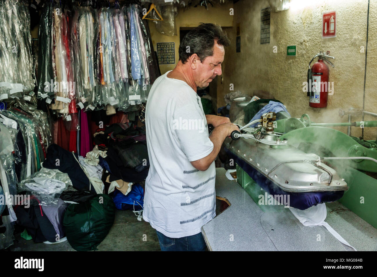 Mexico City,Cuauhtemoc,Mexican,Hispanic,historic Center Centre,Calle Regina,dry cleaner cleaning,man men male,working,pressing,ironing,steam,manager,e Stock Photo