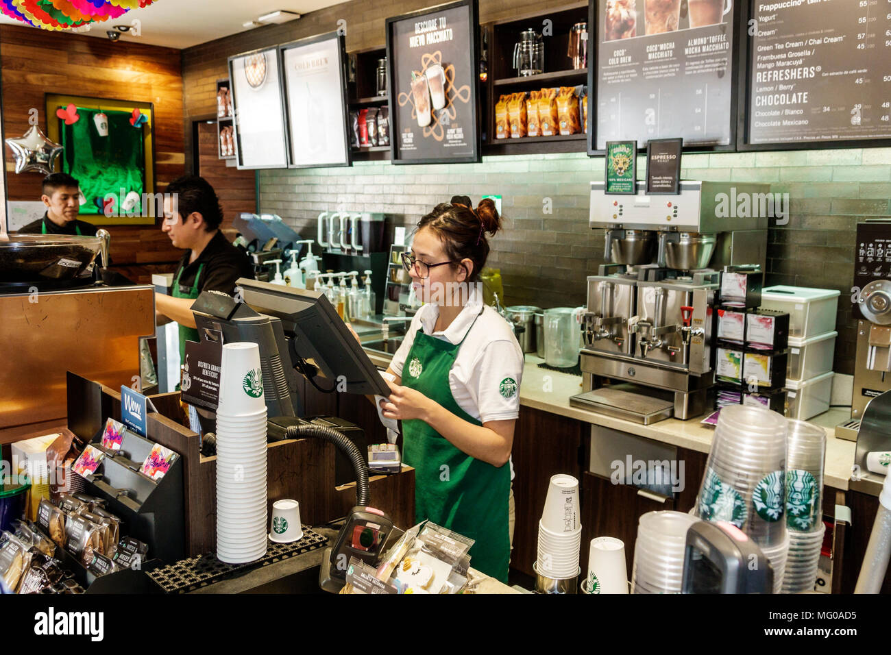 Mexico City,Mexican,Hispanic,historic Center Centre,Calle Bolivar,Starbucks Coffee,coffeehouse,cafe,cashier,woman female women,man men male,employee e Stock Photo