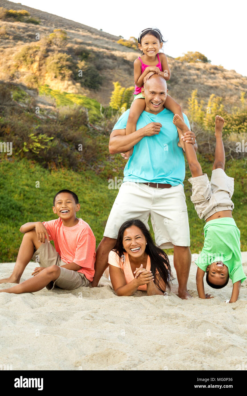Family playing at the beach hi-res stock photography and images - Alamy