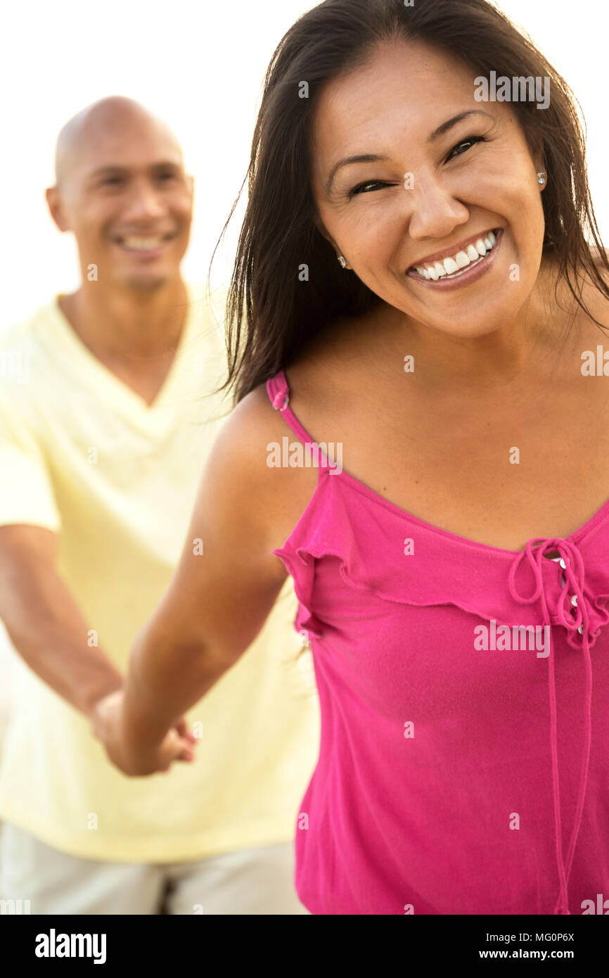 Couple on the beach smiling. Stock Photo