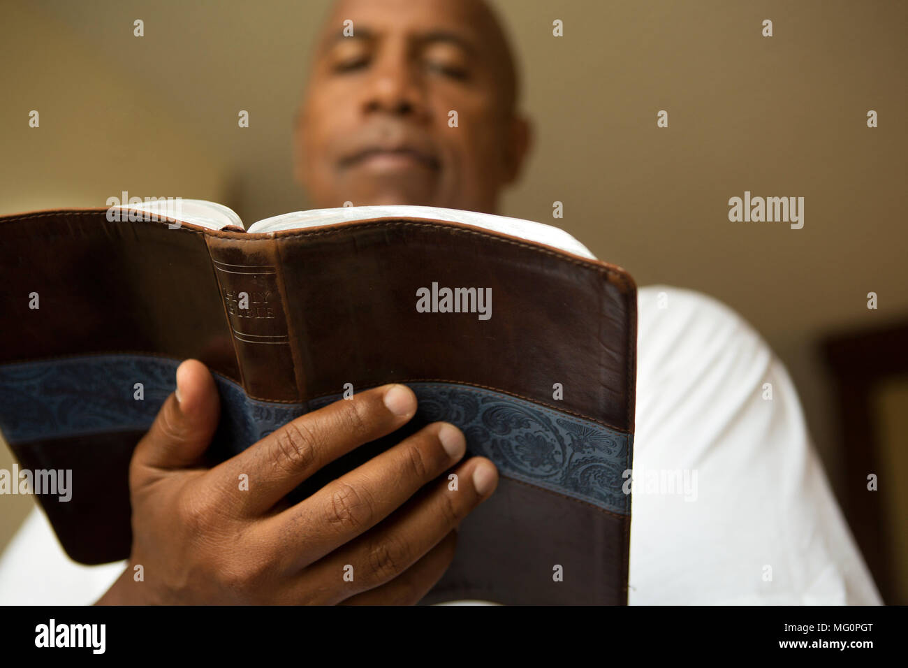 African American man in deep thought and reading. Stock Photo