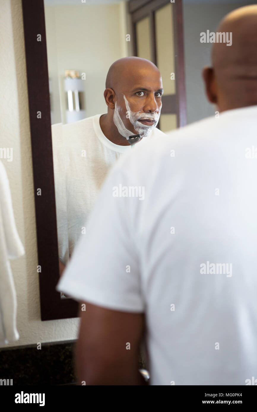 African American man shaving. Stock Photo
