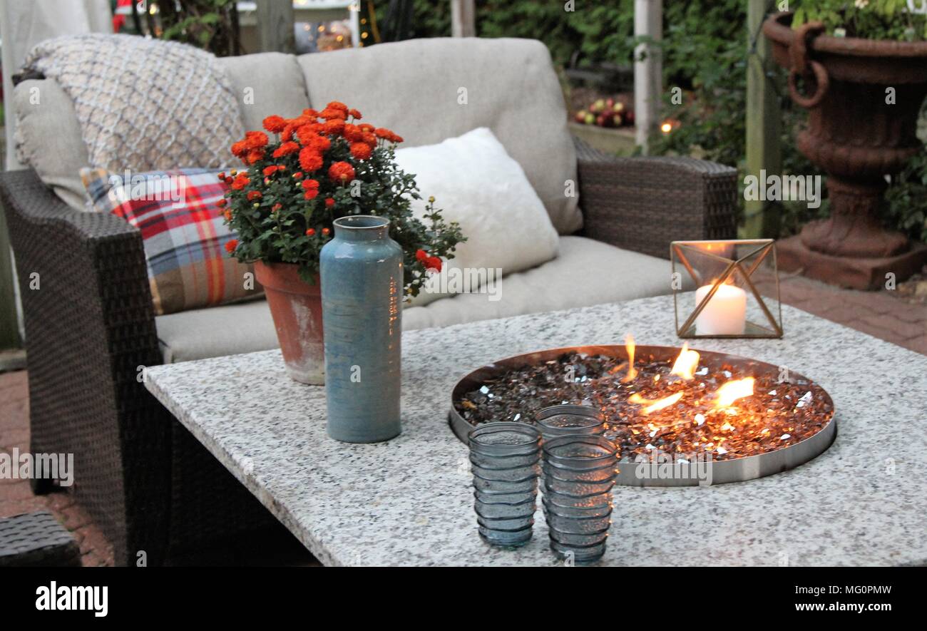 Outdoor Seating Arrangement Around A Gas Fire Pit Table In The