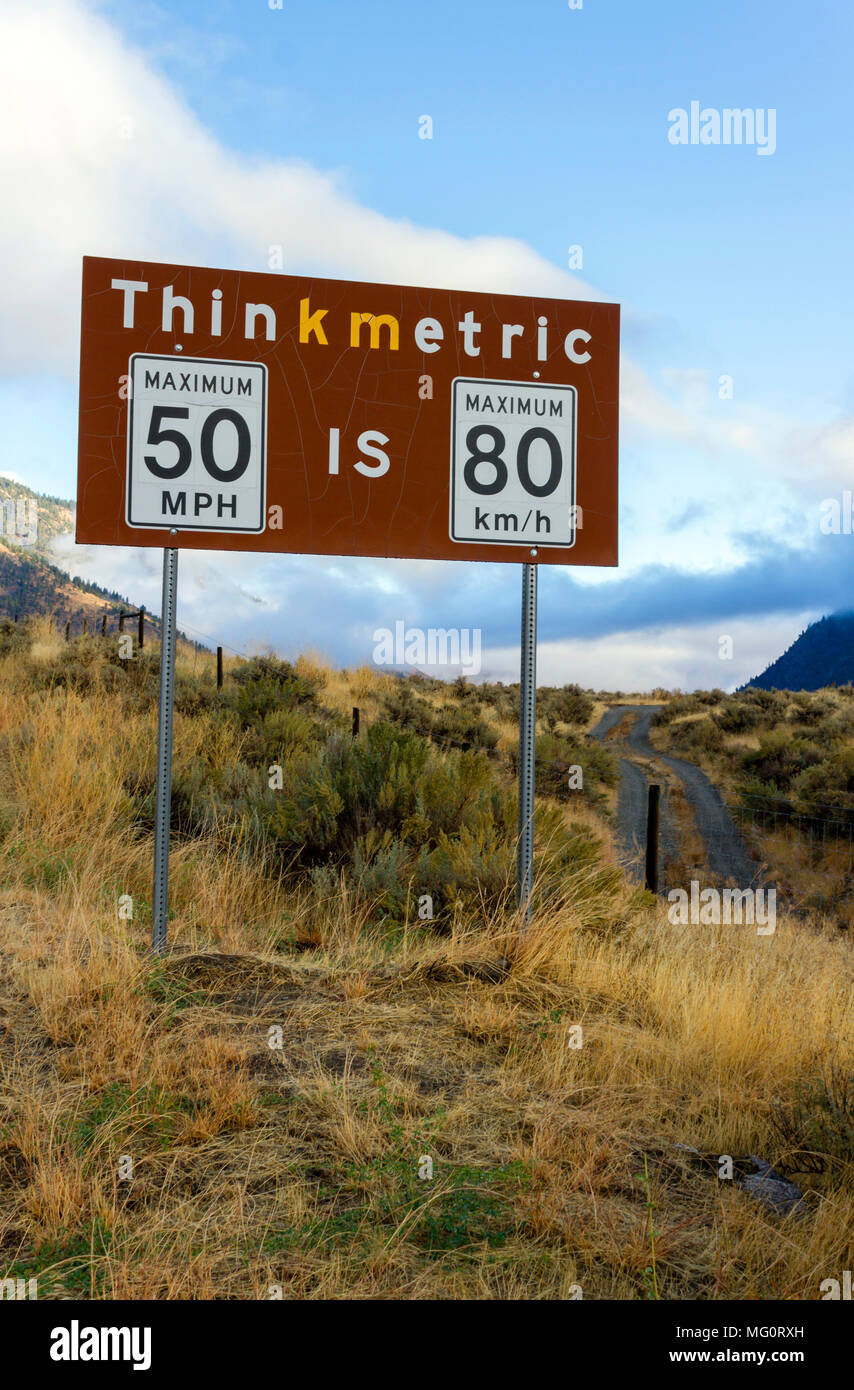 Metric to imperial measurement speed limit sign from miles per hour to kilometers per hour at the Nighthawk border crossing in British Columbia, Canad Stock Photo