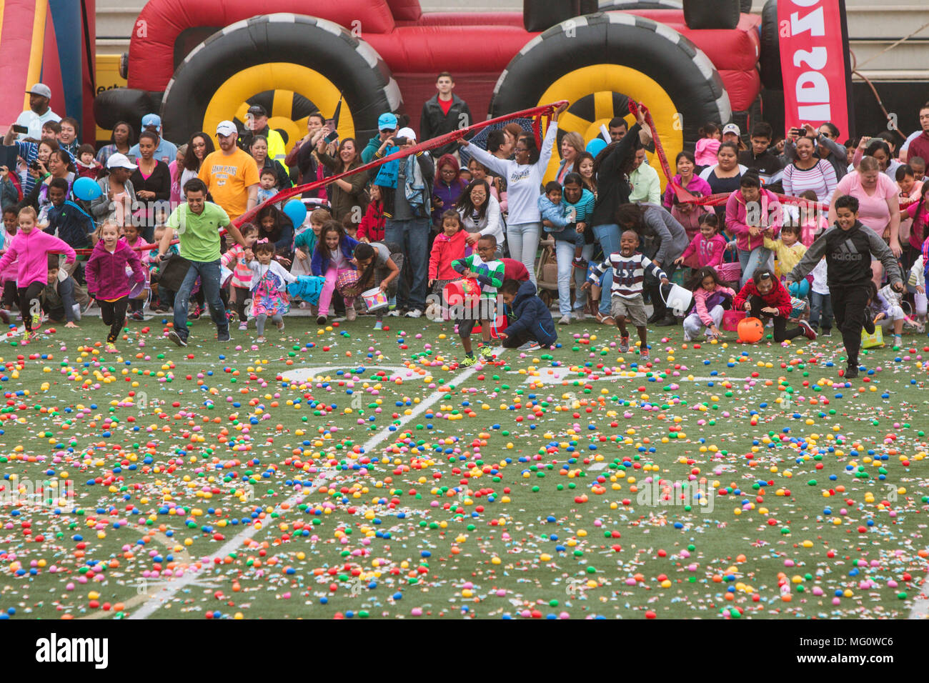 Children and parents dash out onto the football field at Sprayberry
