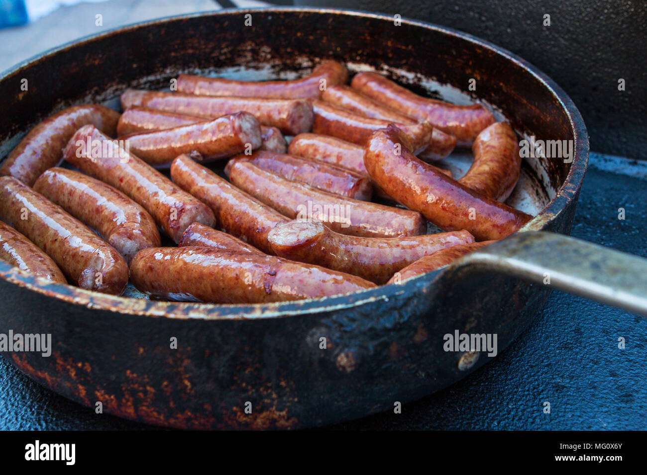 Sausages Cooking In Frying Pan Stock Photos & Sausages Cooking In