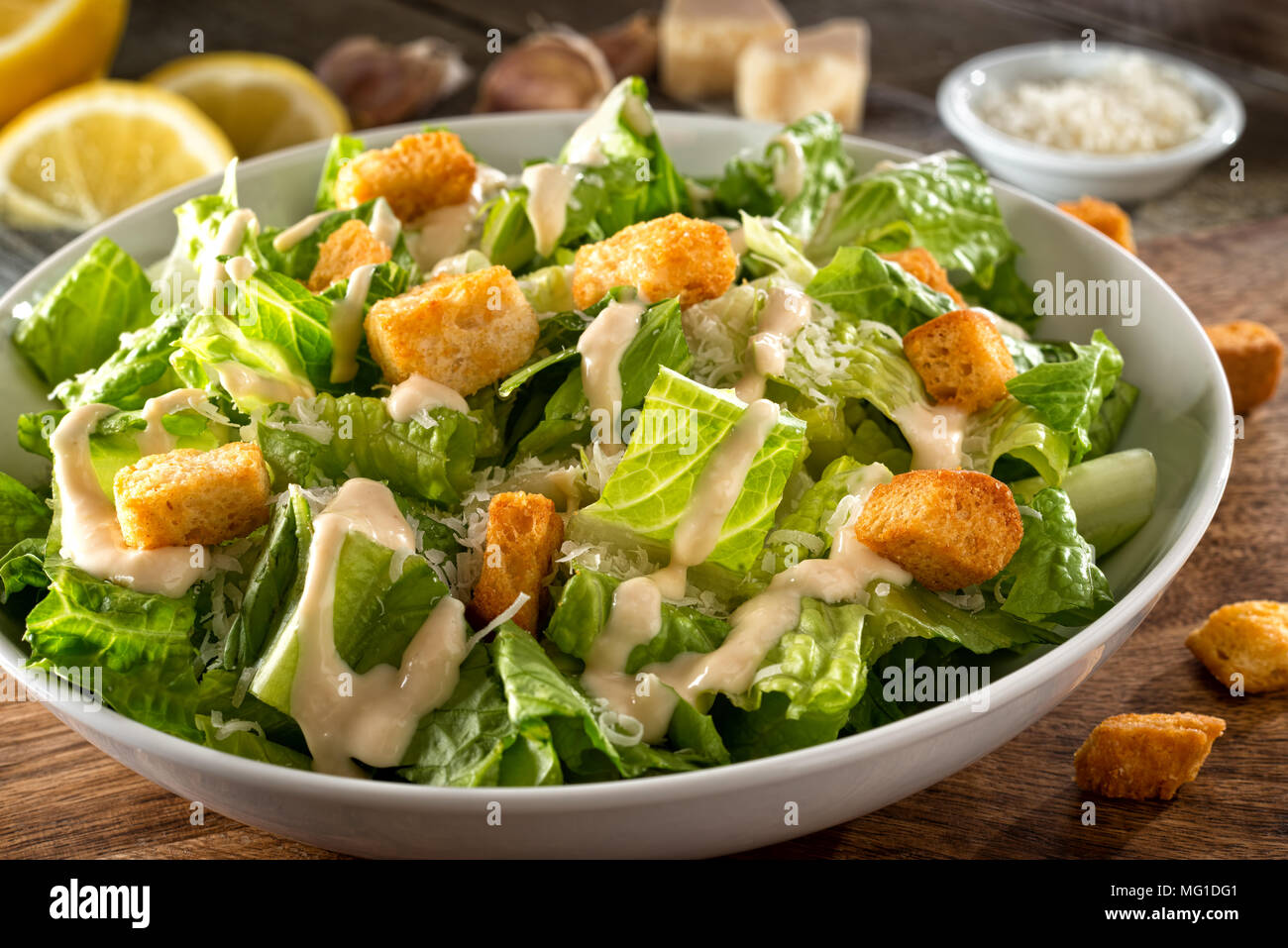 Delicious caesar salad with parmesan cheese, homemade croutons and dressing. Stock Photo