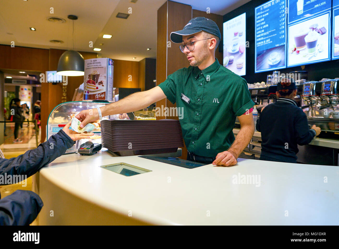 Mccafe Worker MILAN, ITALY - CIRCA NOVEMBER, 2017: worker at a McCafe coffee shop ...