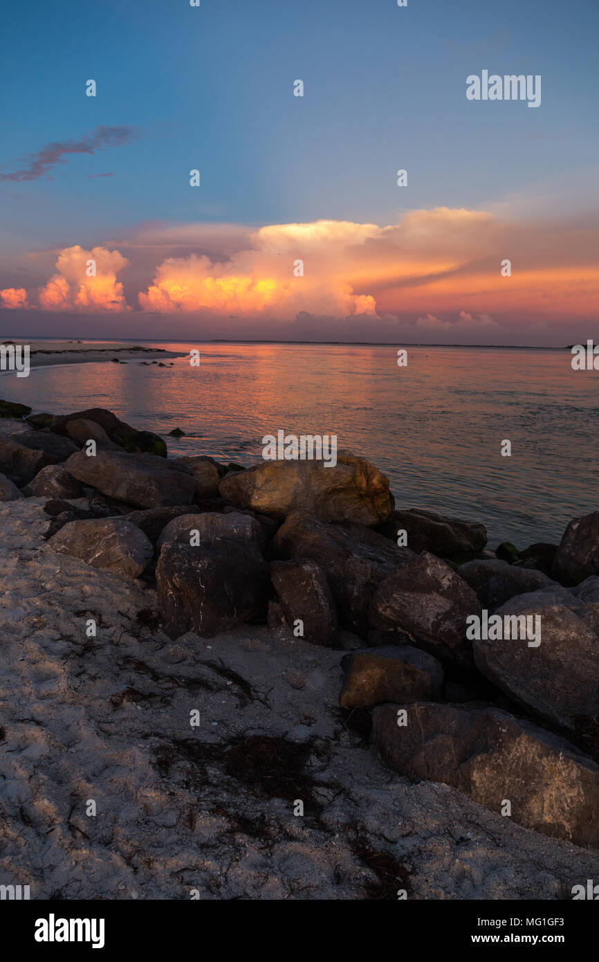 Distant thunderstorms over water during sunset, Boca Grande FL Stock Photo