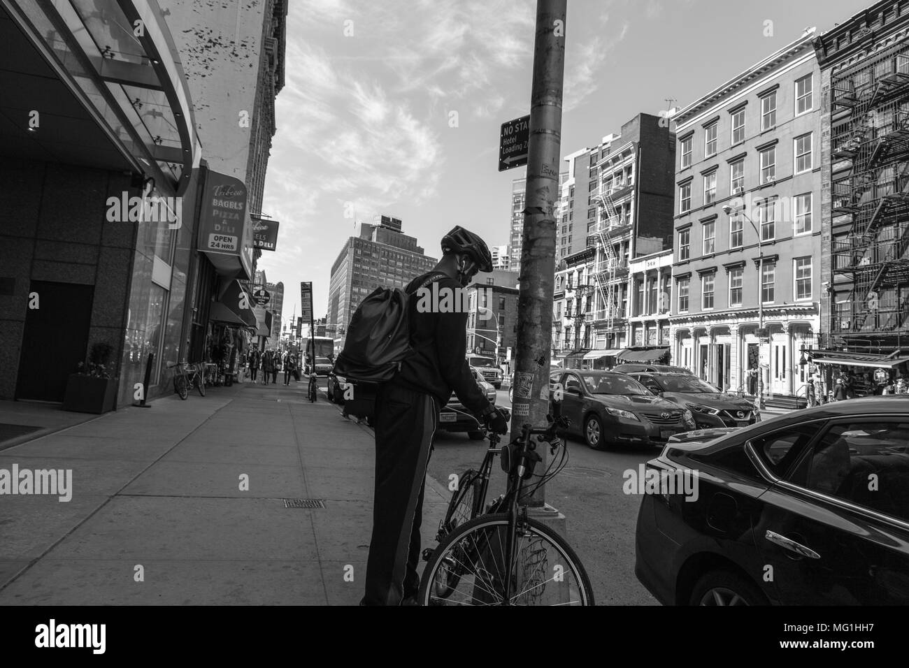 Guy with bike on Manhattan sidewalk Stock Photo