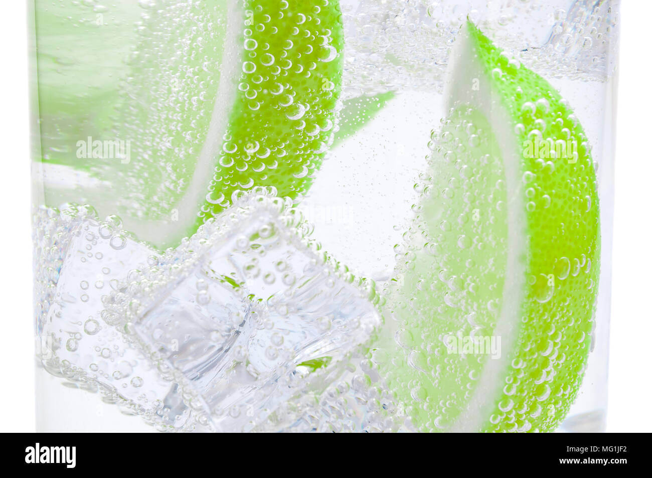 Pieces of fresh juicy lime sink into crystal clear water Stock Photo Alamy