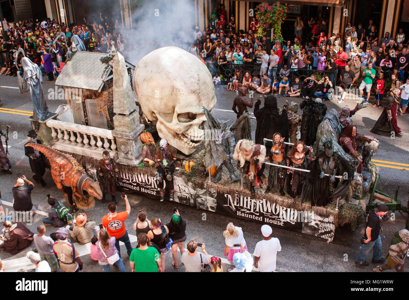 A huge parade float with a giant human skull promotes a haunted house ...