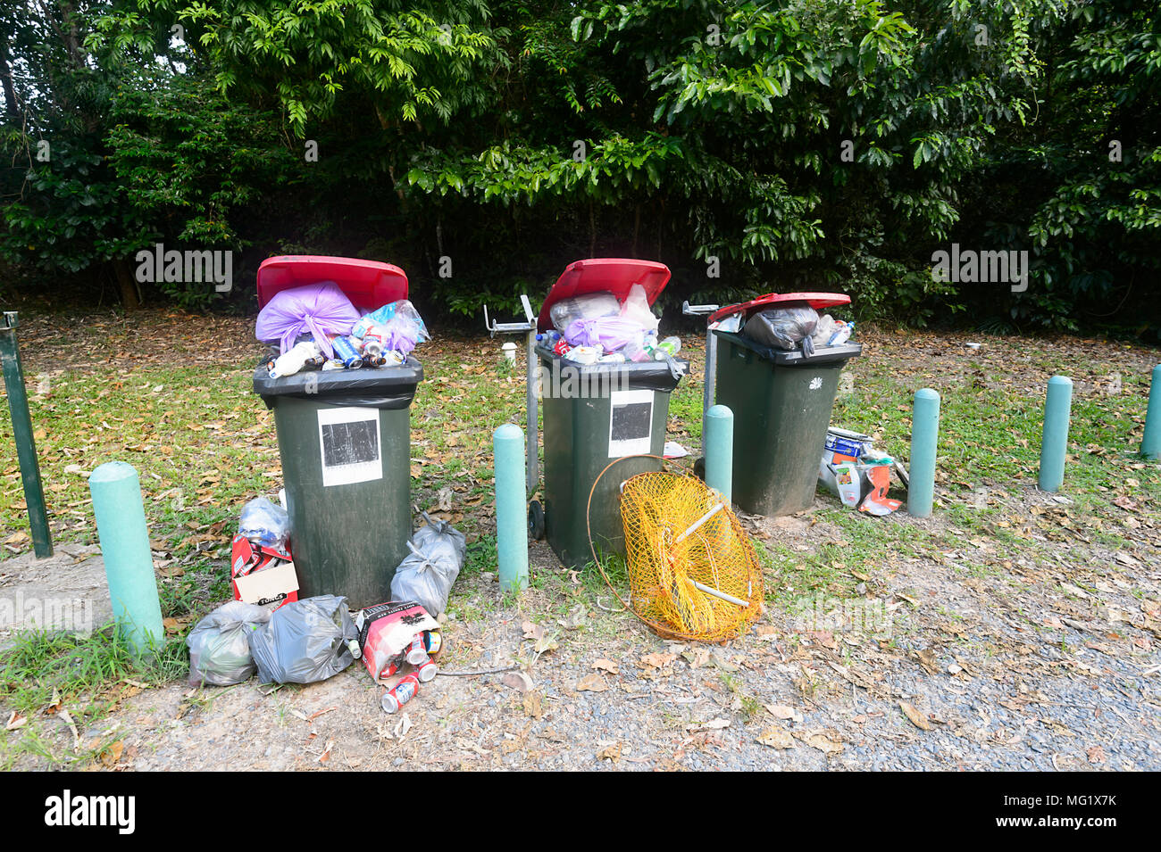 Rubbish overflowing from dustbins in a park in Queensland, Australia Stock Photo
