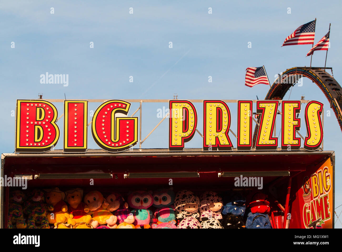 "Big Prizes" sign sits atop carnival game filled with stuffed animals