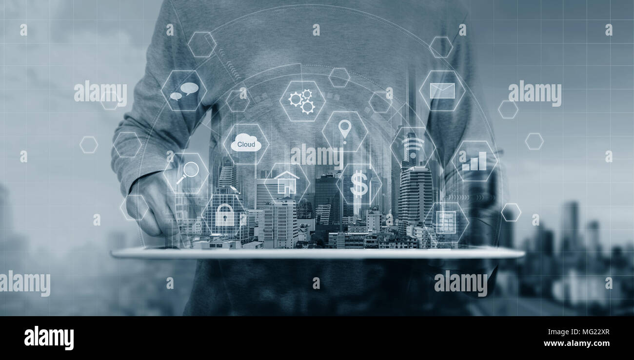 a man using digital tablet and interface online application icons Stock Photo