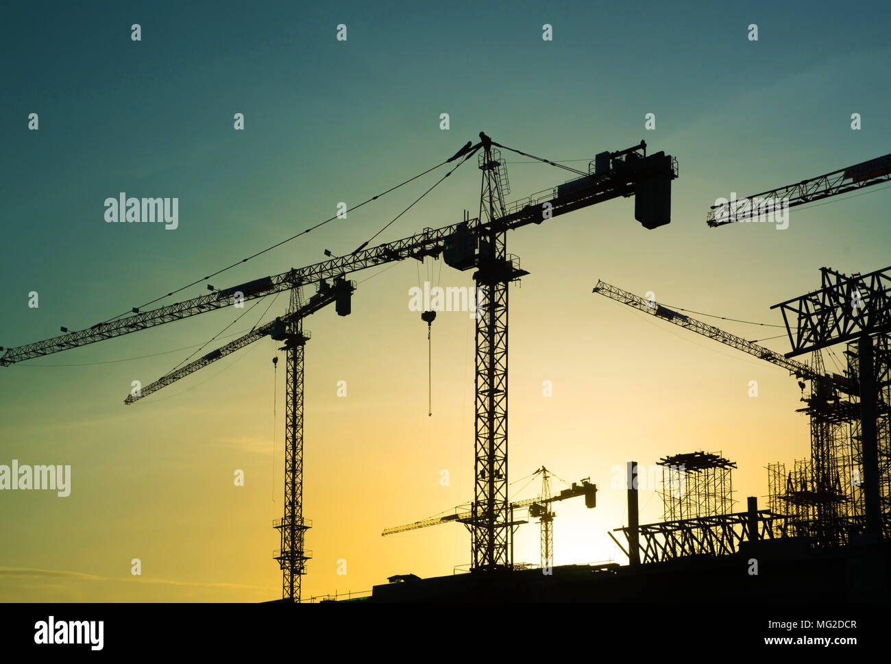 construction crane over tower building site silhouette sunrise ...