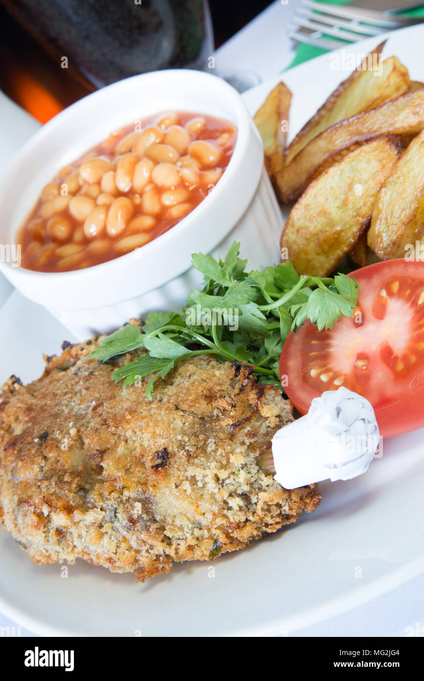 Classic English pub dish of Durham cutlet with chips/fries and baked