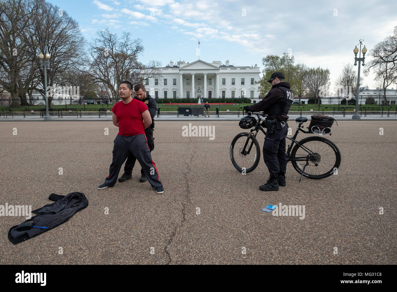 WASHINGTON DC, APRIL 11, 2018 - Secret service police officers arrest peaceful protester who refused to get off the street in front of the White House Stock Photo