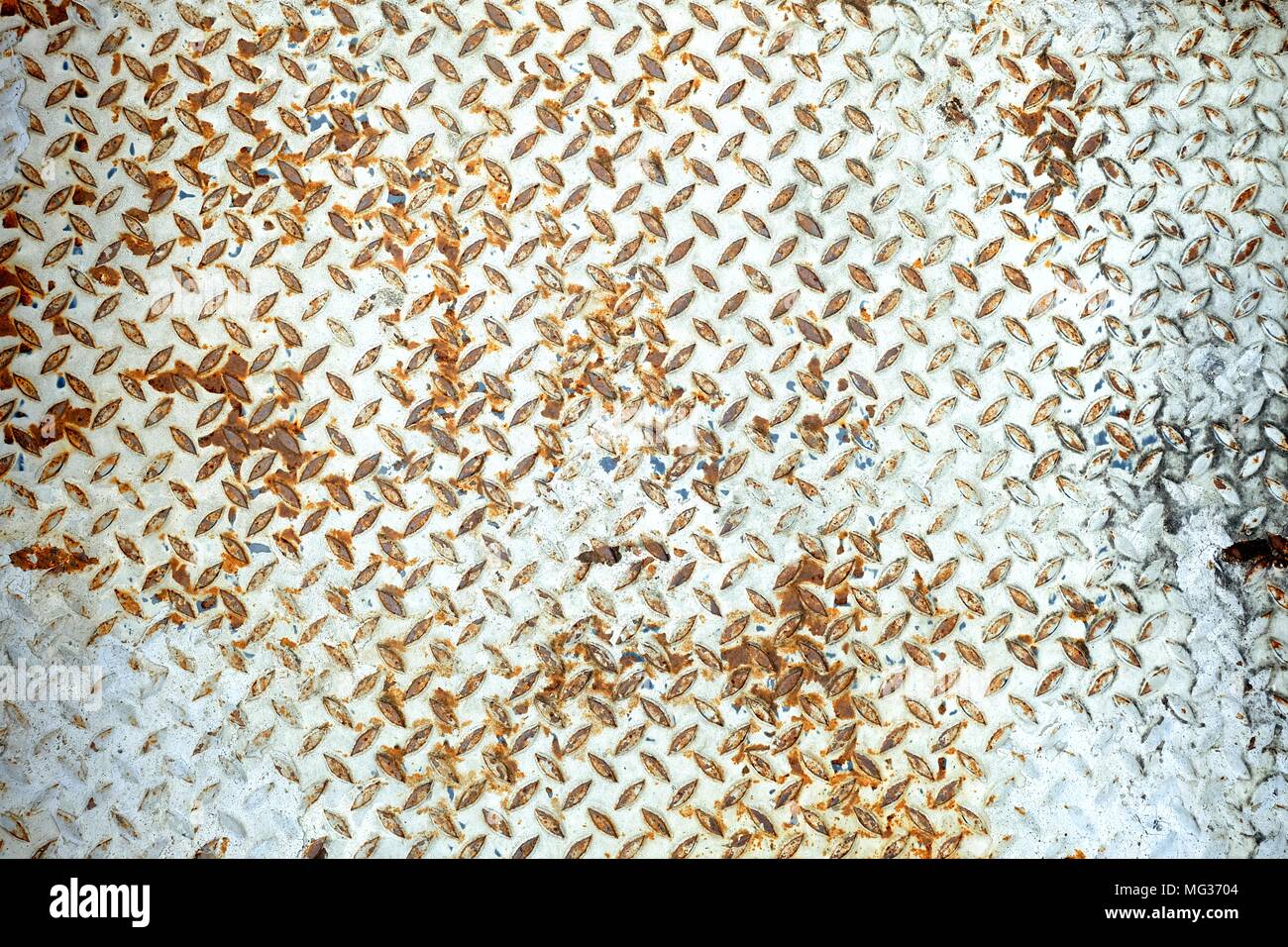 White Peeling Paint  on Diamond Plate Wall. Stock Photo