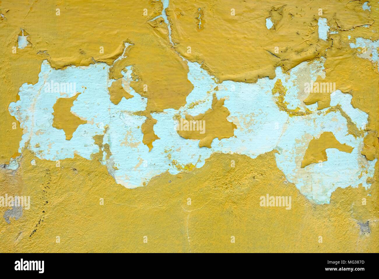 Yellow Peeling Paint on Concrete Wall Background. Stock Photo