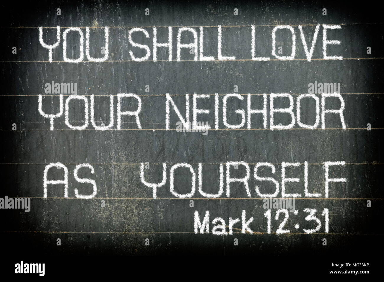 'YOU SHALL LOVE YOUR NEIGHBOR AS YOURSELF' Bible Verse Chalk Writing on Old Chalkboard Background. Stock Photo